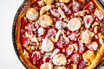 Rhubarb and strawberry tart with mint and sugar. Background with pie texture. Close-up, top view.