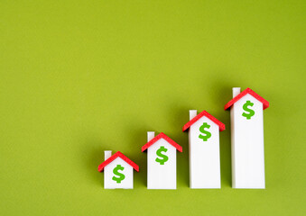 Houses in the form of a graph of housing price growth. Rising property prices, touching on housing...
