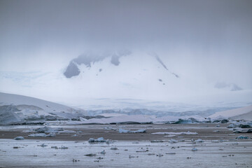Beautiful paradise harbor in Antarctica under overcast sky