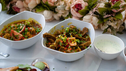 Delicious Indian Curry Dishes Served in White Bowls