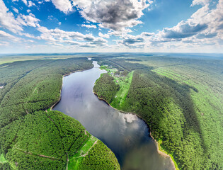 Big lake with green shores in bright sun light, aerial landscape. Recreation concept. Aerial view