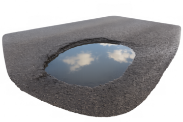 Pothole reflecting cloudy sky on damaged asphalt road with transparent background
