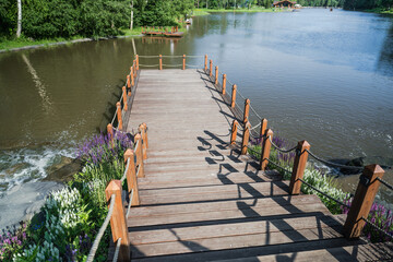 An Idyllic Wooden Dock Beautifully Overlooking Serene Waters, Lush Greenery, and Nature