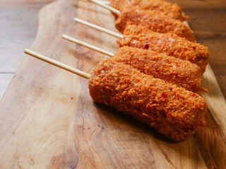 Pile of fancy kebabs on wooden sticks on wooden cutting board. Tasty meal made from fine beef or...