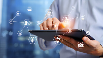 Business Professional Interacting with Digital Network on Tablet A person using a tablet to access a virtual network of business and social media icons in a corporate setting