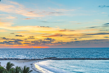 Scenic view of the beach and ocean in Cancun Hotel Zone at sunset with vivid colors in the sky and gentle waves along the shoreline High-quality photo