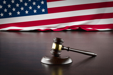 American Flag and Wooden Gavel Resting on Desk.