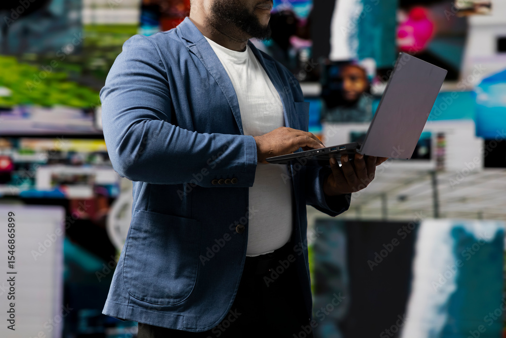 Poster young black professional explores a tech driven environment with visual data, content feeds and appl