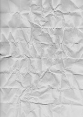 Obraz premium Crumpled and flattened white paper sheet with textured surface. Natural wrinkles and creases form an abstract background. Perfect for grunge effects, recycled material themes