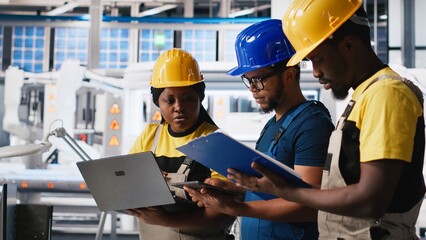 Technicians group in photovoltaics factory use tracking software on devices, troubleshooting for...