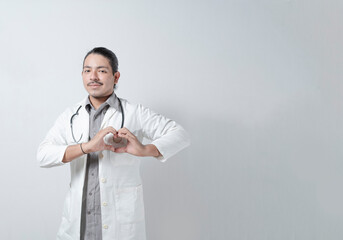 Young doctor heart hand in stethoscope