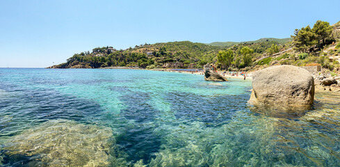 View to Cannelle beach, Spiaggia delle Cannelle, near Giglio Porto with view to mediterranean sea and beautiful blue bay at Isola del Giglio, island of the tuscan archipelago, Grosseto Tuscany Italy