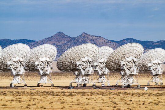 Telescope antennae in the Very Large Array with mountains in the background at the National Radio Astronomy Observatory (NRAO) near Socorro New Mexico