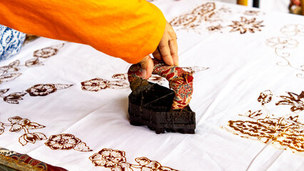 The process of making batik cloth. Batik is a type of cloth whose motifs are made manually,...