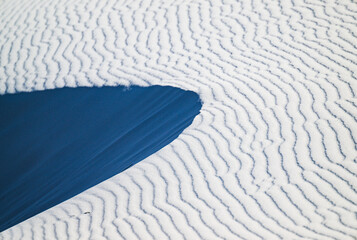 Stark white patterned sand dune with a shaded slope at White Sands National Park, New Mexico