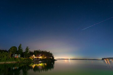 Subtle hint of color from the Northern Lights illuminates the night sky behind Lummi Island,...