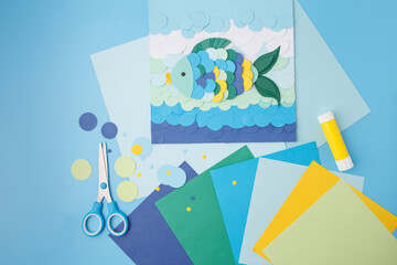 Colorful fish paper artwork with sea-inspired waves and craft tools for DIY brands, paper supply...