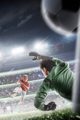 Goal. A football player scores a goal in a match. The goalkeeper misses the ball. The final match in an arena full of cheering fans. Sports. Vertical