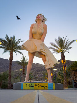 Palm Springs, California, USA - April 16, 2024: Low angle view of the Forever Marilyn Statue by Seward Johnson against mountain and blue sky after sunset