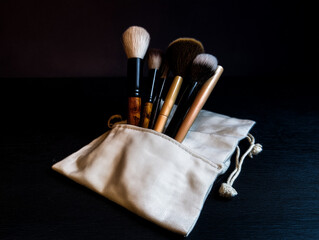 Makeup Brush Set on Linen Pouch, Dark Background