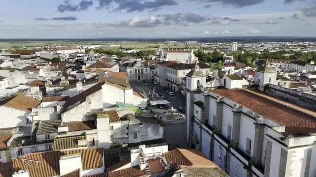 Drone flies south over Pra&ccedil;a do Giraldo in the late afternoon in Evora, Portugal