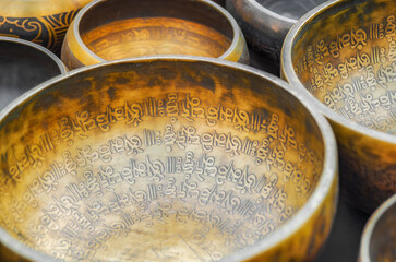 Intricately engraved brass Tibetan singing bells used for meditative purposes