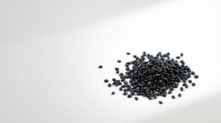 Black Seeds Scattered on White Background, Close Up View