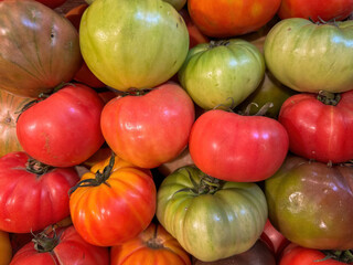 Full frame picture of green and red tomatoes on a stack