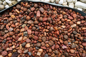Frame full of decorative brown and white stones. Texture. Background.