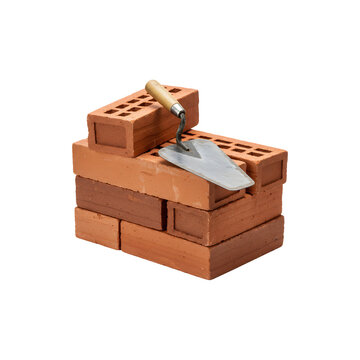 Fototapeta Stack of red bricks with a trowel on top, representing construction or masonry work