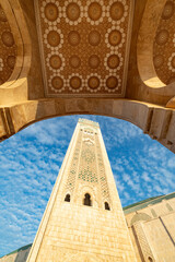 Ornate mosque minaret, arched entryway.
