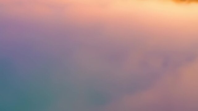 Soft pastel colored clouds drift gently creating a peaceful atmosphere