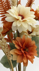 This image presents a beautiful faux floral bouquet with orange and cream blossoms.