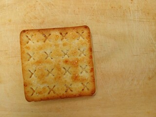 Classic plain cracker biscuits on a wooden board