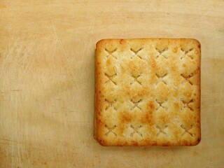 Classic plain cracker biscuits on a wooden board