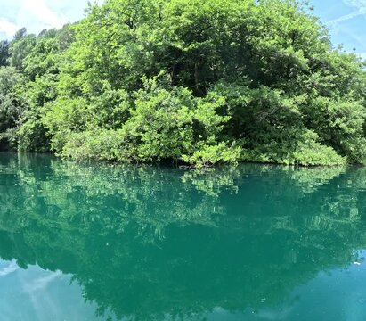 Lake of Levico in Trentino, northern Italy, seen during a hike on a stand up paddle board on a beautiful day in June