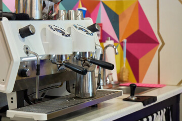 Espresso Machines with Geometric Mural Background in Cafe
