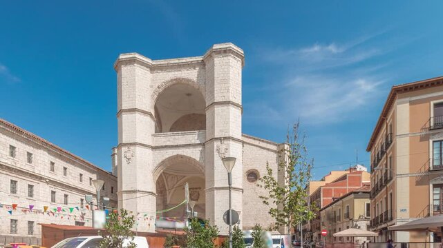 Panorama showing church of San Benito el Real timelapse, a historic Benedictine monastery in Valladolid, Spain. The Gothic-style facade stands tall under a blue sky, essence of medieval architecture.