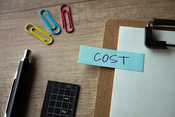 There is sticky note with the word COST. It is as an eye-catching image.
