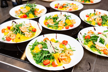 Colorful shrimp salad with arugula and citrus.