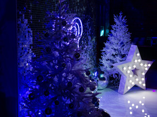 White Christmas Trees with Neon Blue Lights.