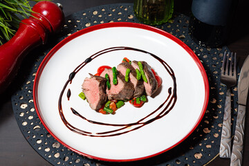 Gourmet beef tenderloin with balsamic drizzle.