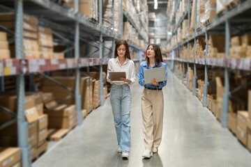 Female engineers team discussing inventory in warehouse logistics and supply chain planning,...