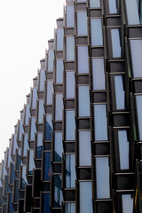 The building has a lot of windows and a lot of brown trim