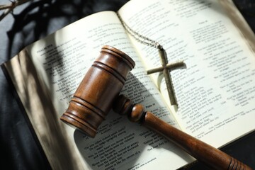Judge's gavel, Bible and cross on black table, top view