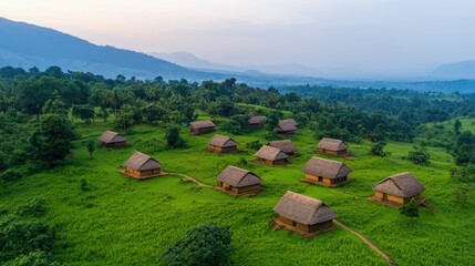 Aerial panoramic view of a traditional African village nestled in a lush verdant countryside landscape with huts hills and mountains in the distance
