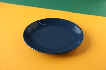 One empty plate on color background, closeup