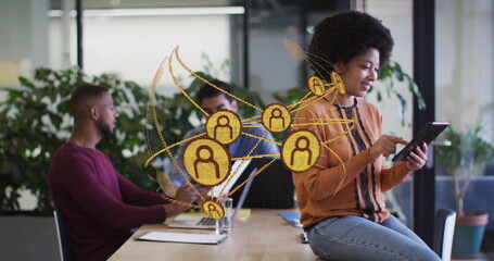 Tapping mid African American woman using tablet in office meeting area, network graphic, copy space