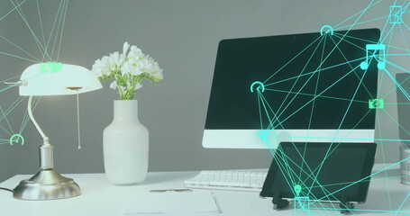 Showing monitor above keyboard on office desk, metallic pull-chain lamp, tablet and digital overlay