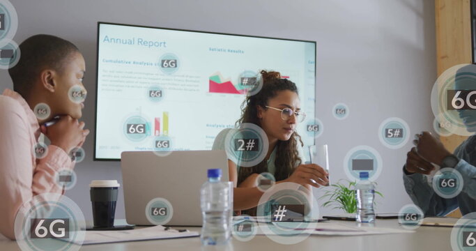 Three professionals reviewing 6G annual report charts in conference room, with laptop, coffee cup